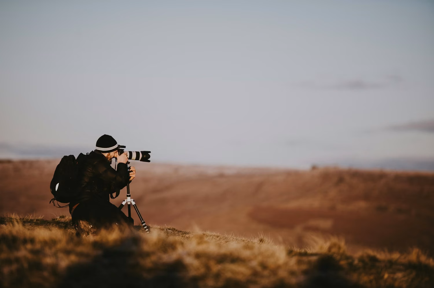 Man using black DSLR camera during daytime