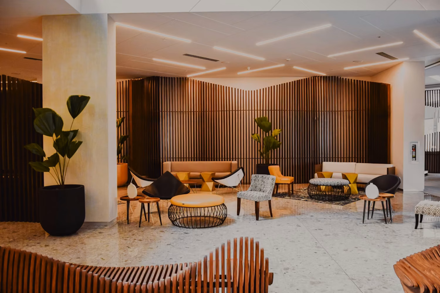 Modern hotel lobby with designer furniture and wood walls