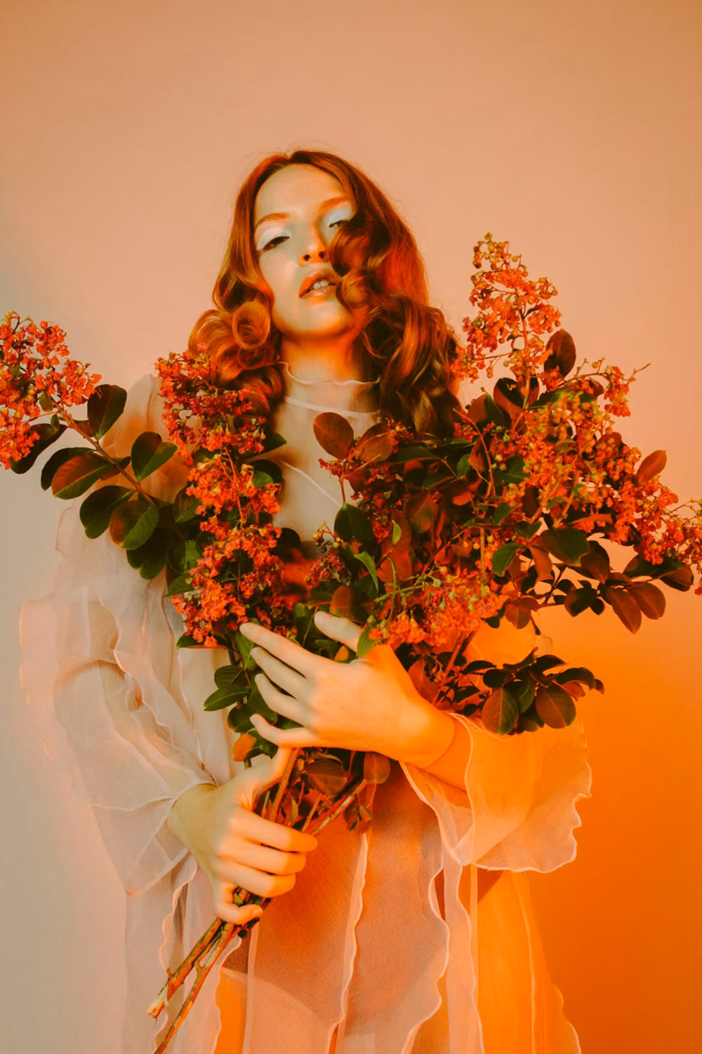 Woman in white wedding dress holding bouquet of flowers