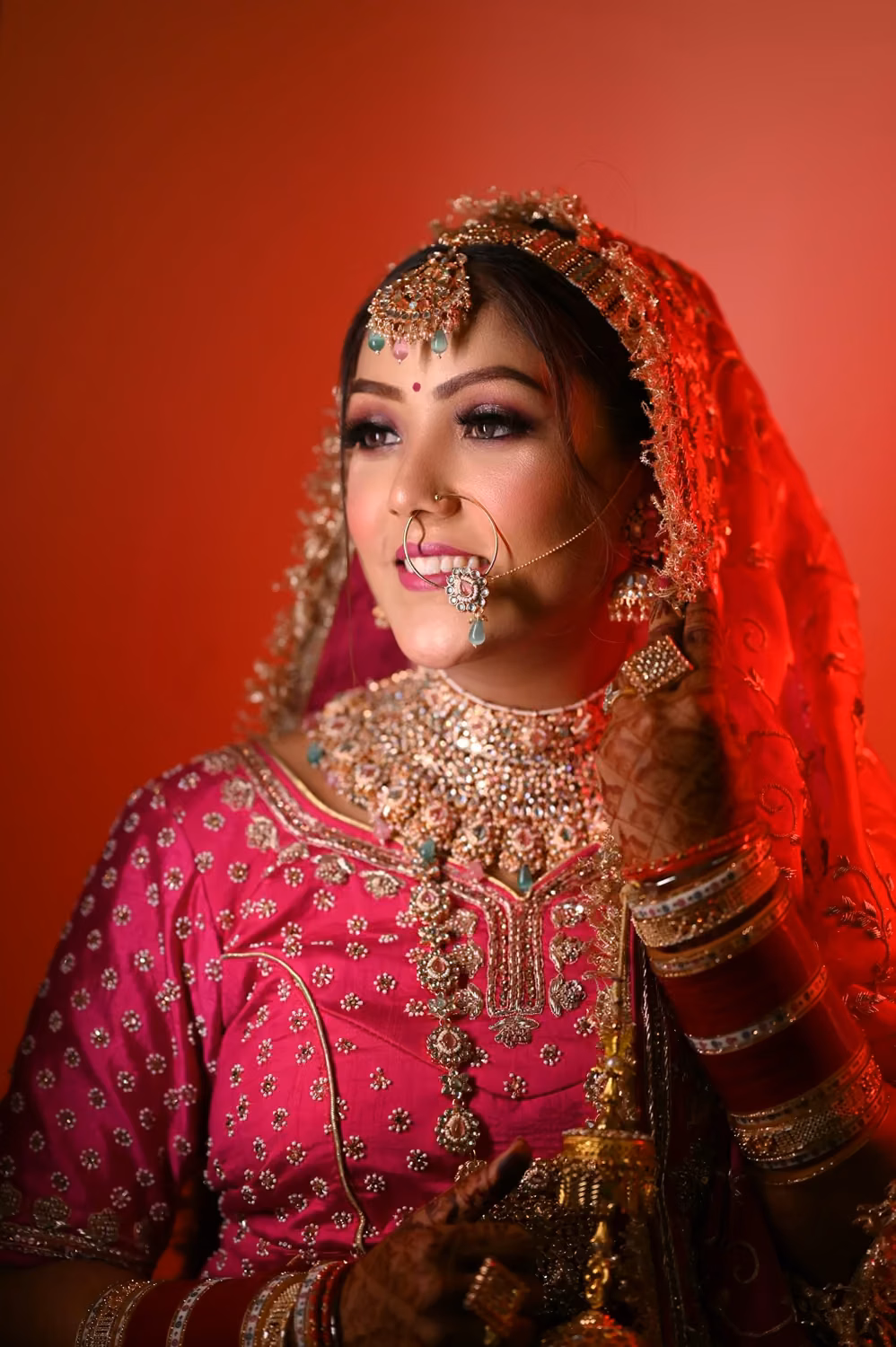 A woman in a pink outfit with a nose ring
