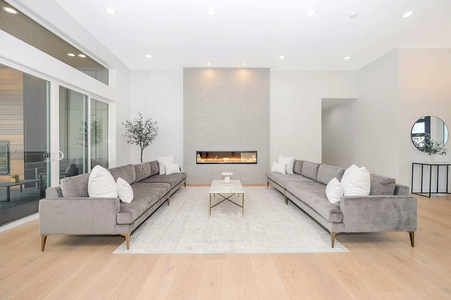 Two grey velvet sofas facing each other in a bright modern living room