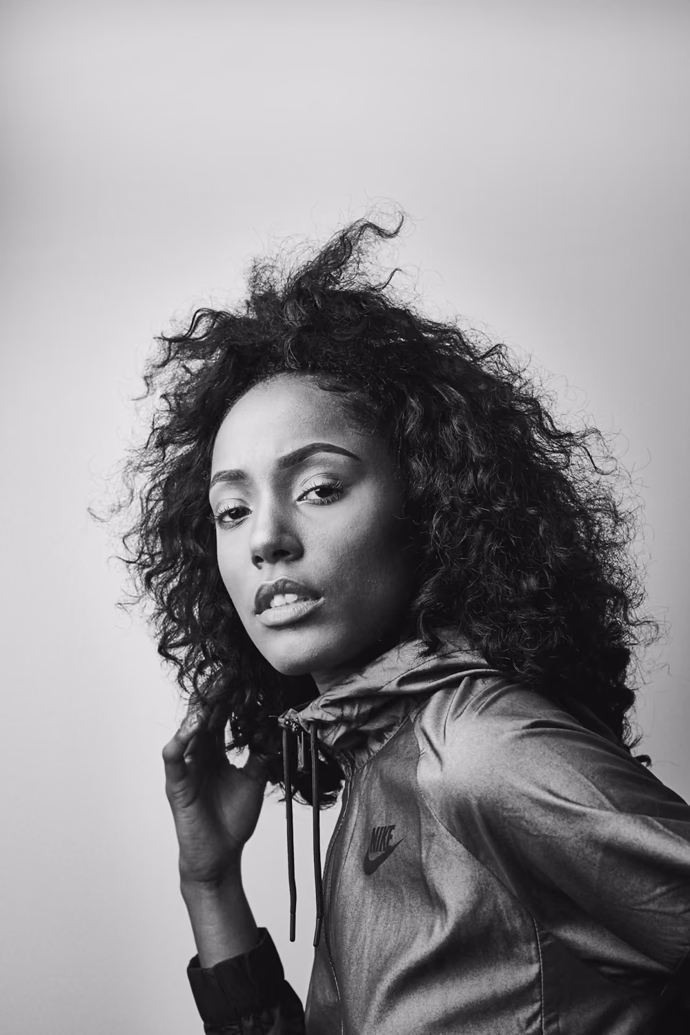 Grayscale photo of woman in black leather jacket